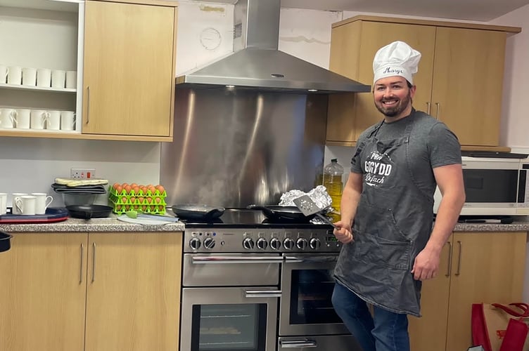 Caerwedros breakfast: FUW Ceredigion County Chairman Morys Ioan cooking up a storm