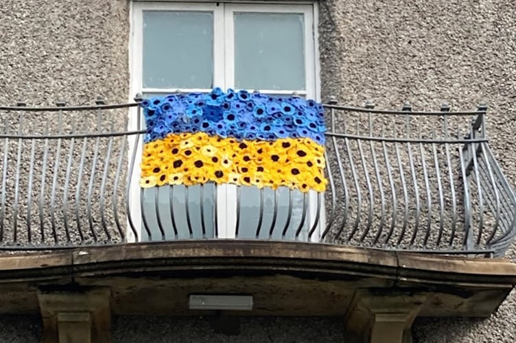 A group in Criccieth that made a gown of poppies has turned its attention to Ukraine. The group has now made a Ukrainian flag in support of its people. It can be seen here, hanging from the balcony of Criccieth Memorial Hall.
