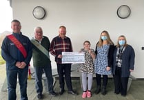 Lodge brothers present cheque to school