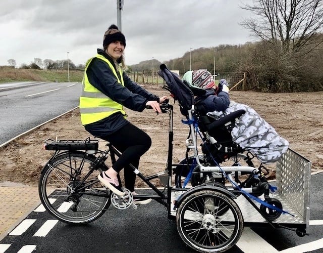 Club riders Catherine and Will are pictured here using the club’s pedal assisted electric wheelchair carrier