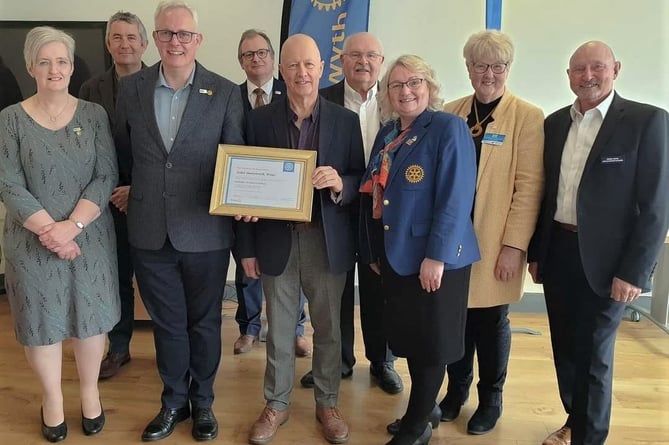Pictured are Rotarians with Aberystwyth Mayor, Cllr Alun Williams (centre, holding the Charter), Rotary District Governor Ray Bevan (to his right)