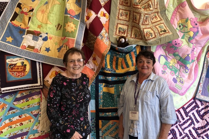 Janet Thomas and Jenny Jenkins of the Aberystwyth Linus Project were thrilled by all the quilts members of the Welsh Heritage Quilters had made for children in need of comfort