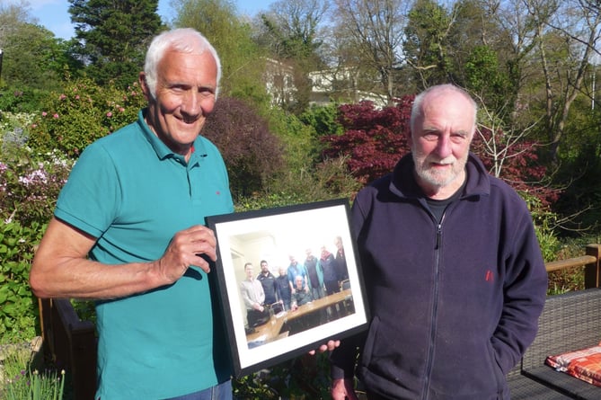 Mike Walker (left) presents a framed photograph to Adrian Kendon (right) to mark his retirement as Chair of Traws Link Cymru