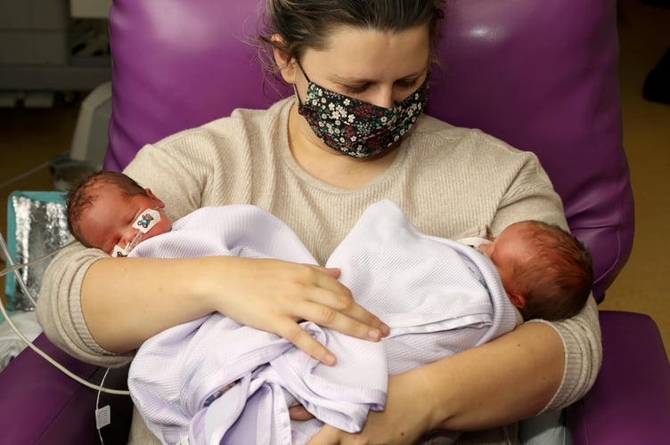 Kara Penfold and her baby twins Lleucu (L) & Nico (R) Penfold.  Twins born just TWO minutes apart have two different birthdays after they were delivered either side of midnight.  See SWNS story SWMDtwins.  Kara Penfold, 29, welcomed little Nico and Lleucu into the world at Wolverhampton's New Cross Hospital after travelling from her home in Cardiff.  Nico was born at 11.59pm on April 8, weighing 4lb 12oz, with Lleucu following shortly after at 12.01am on April 9, weighing 4lb 9oz.  The twins were eight weeks early and were delivered following a planned c-section after Kara had a previous traumatic experience resulting in the loss of her first child. 
