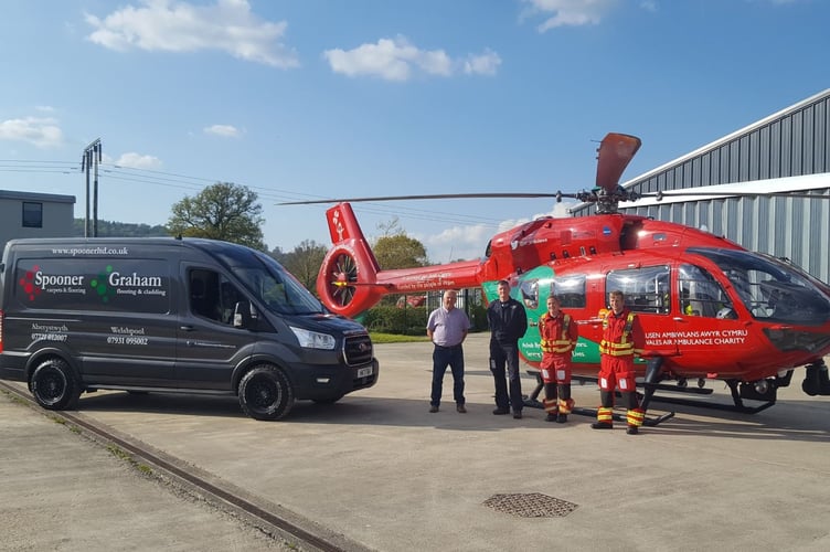 Wayne Spooner is pictured with the Wales Air Ambulance pilot and medics