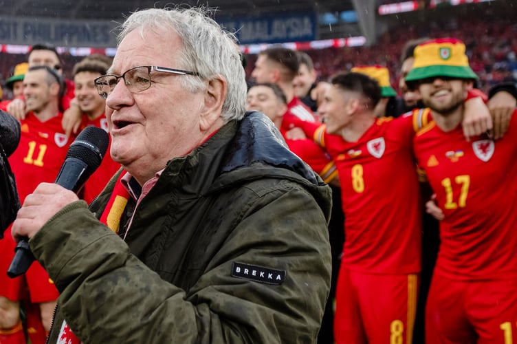CARDIFF, WALES - 05 JUNE 2022: Wales celebrates while  Dafydd Iwan sings after beating Ukraine 1-0 to book a place at the 2022 FIFA World Cup at the Cardiff City Stadium on the 5th of June 2022. (Pic by John Smith/FAW)