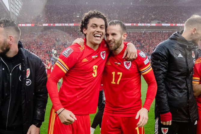 CARDIFF, WALES - 05 JUNE 2022: Wales' Brennan Johnson  and Wales' Rhys Norrington-Davies celebrate after beating Ukraine 1-0 to book a place at the 2022 FIFA World Cup at the Cardiff City Stadium on the 5th of June 2022. (Pic by John Smith/FAW)