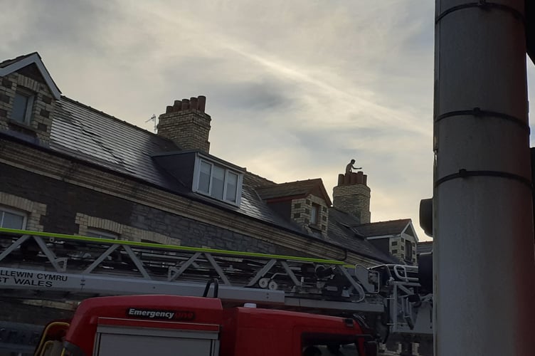 Person on roof Northgate Street, Aberystwyth, road closed