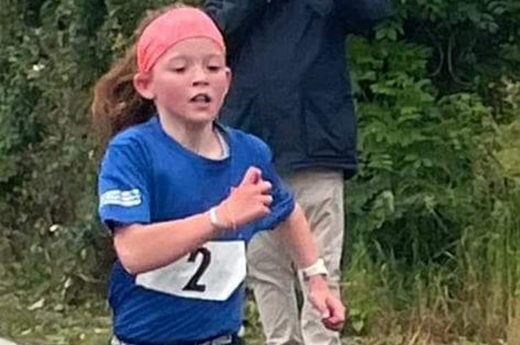 Yasmin Evans finishing first in her race for girls in Years 4-6 at Felinfach