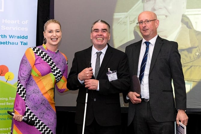 Paul Clasby, pictured in the middle, has received the TPAS Tenant of the Year Award for 2022 for his contribution as chair of the Barcud Monitoring Group