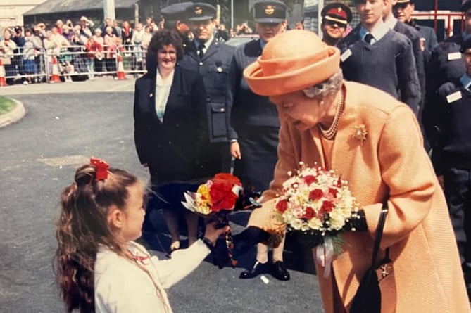 Eleri Williams presents flowers to Queen Elizabeth in Aberystwyth in 1996