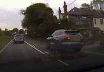 Jaguar driver overtakes three cars approaching a blind bend on A487
