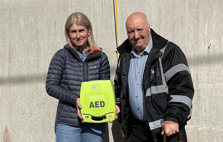 Erika and Kenneth are pictured with a lifesaving defibrillator