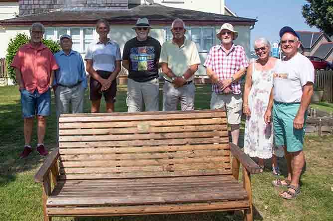 Former Aberystwyth Lions members with the memorial bench at HAHAV’s Plas Antaron in Penparcau
