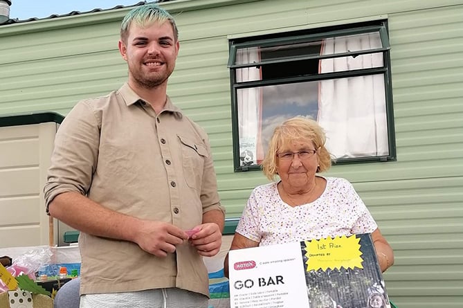 Aberystwyth Morrisons community champion Evans Tudor attended presented the winner of the raffle with their prize