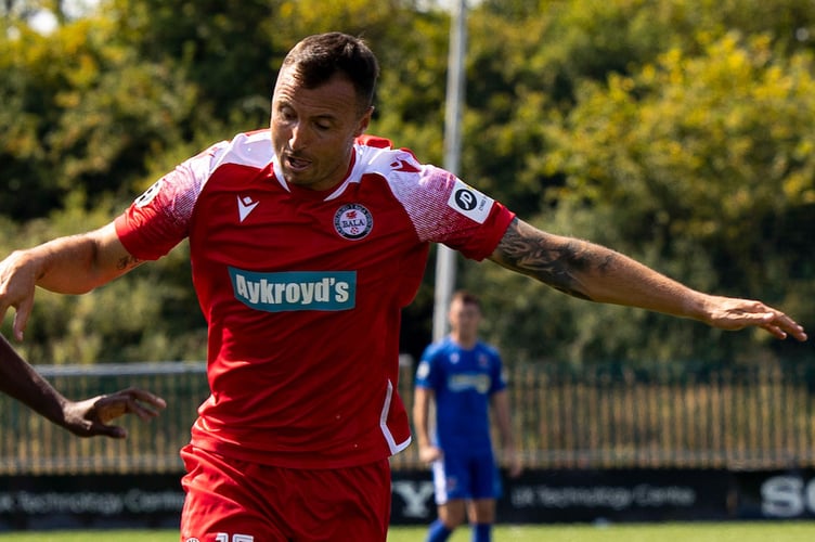 Bridgend, WALES -  14th August, 2022: 
Keyon Reffell of Penybont in action against Anthony Kay of Bala Town.
Penybont v Bala Town in the JD Cymru Premier at the SDM Glass Stadium on the 14th August 2022. (Pic by Lewis Mitchell/FAW)