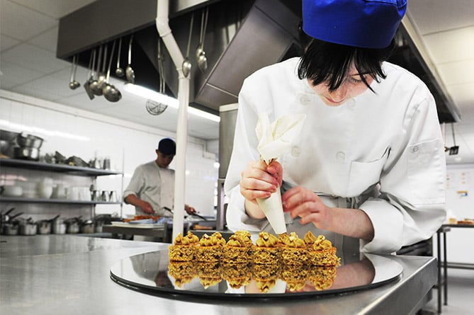 A professional cookery and hospitality student working at Coleg Ceredigon’s Bwyty Maes y Parc training restaurant