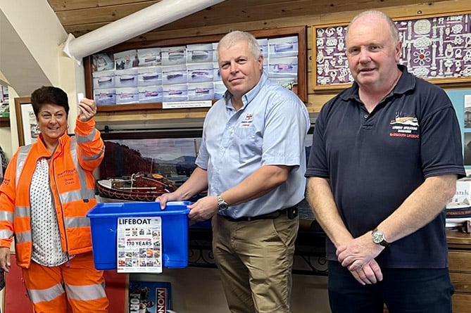 Drawing the winners of Barmouth RNLI’s raffle: Dawn Owen, coxswain Peter Davies and lifeboat operations manager Mark James – see report left