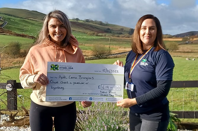 Mared Hopkins presenting the cheque to Bridget Harpwood, one of the fundraising officers at Hywel Dda Health Charities