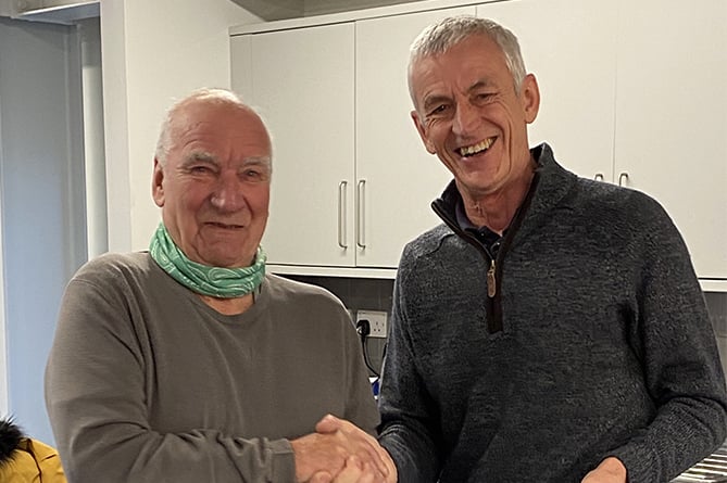 Bernard Roberts receiving his letter of thanks from Pwllheli RNLI lifeboat operations manager Andy Vowell