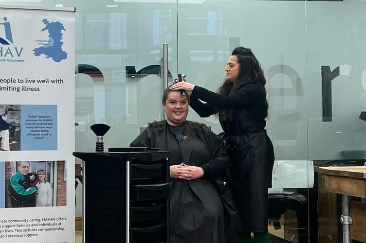Rachel Davies being shaved by Jacquie McCartney of Jago Hair Salon, Aberystwyth