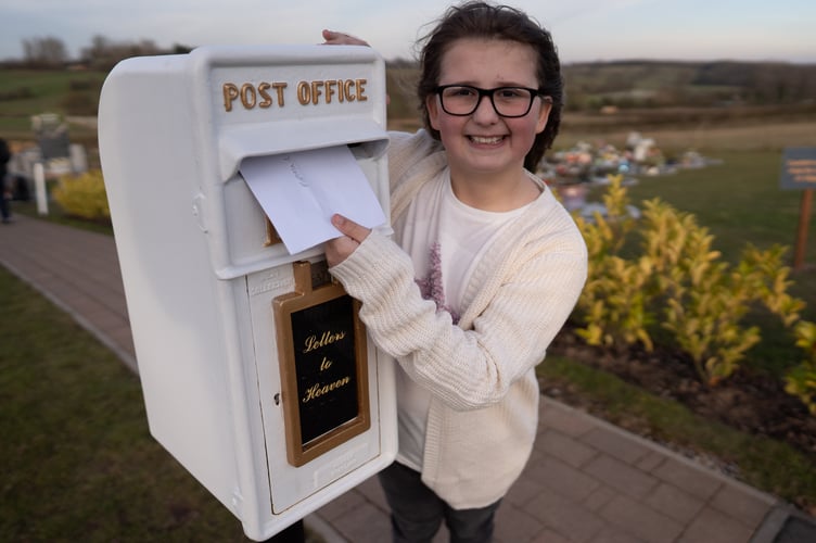 Matilda Handy, 9, and mum, Leanne Handy 45 with their letter box to heaven, in Gedling Crematorium, which allows grieving members of the public to write a letter to their loved ones who have passed away.     A nine-year-old girl's 'postbox to heaven' idea which allows people to send letters to their deceased loved ones is to be rolled out nationally at crematoriums across the UK.  See SWNS story SWLNpost.  Grieving Matilda Handy suggested the heartwarming idea while looking for a way to express her emotions after her grandparents passed away.  The schoolgirl wanted to send her late grandma/nan/gran and granddad letters and cards so her family approached Gedling Crematorium, in Lambley, Nottingham.   Crematorium bosses responded by installing an old Royal Mail postbox painted white just before Christmas, which led to more than 100 letters being posted. The postboxes are now set to be implemented at more than 40 other sites across the country after Matilda's moving tribute to her grandparents proved so popular.    