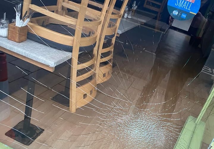 The smashed window at the Little Devil's Cafe