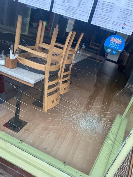 The smashed window at the Little Devil's Cafe