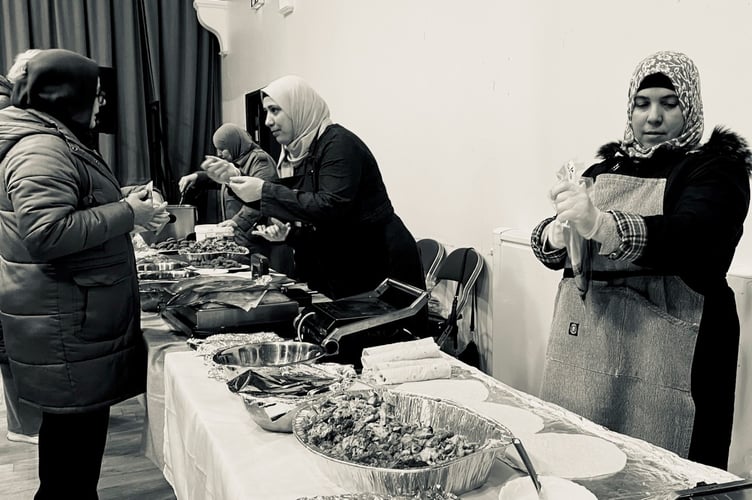 The women served meat or vegetarian bread wraps with salad to those who attended
