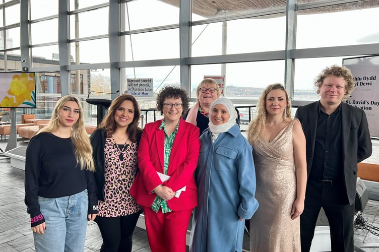 Ghofran Hamza, Latifa Najjar and Batool Abid Raza from Syria and the Middle East, along with Krystyna Makar from Ukraine with Elin Jones MS at the Senedd. Also in the picture are Dr Andrea Hammel, Aberystwyth University, organiser of the exhibition and the accompanist