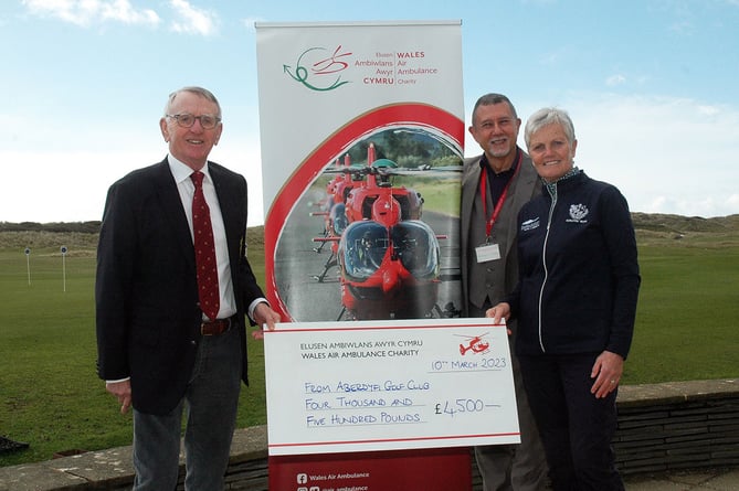 Aberdovey Golf Club 2022 captains Adrian Powell and Mary Upson  with their Captain’s Charity cheque of £4,500 for Wales Air Ambulance. They are pictured with air ambulance representative Julian Evans