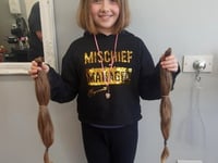 Emily, 11, has hair cut off to help people with cancer
