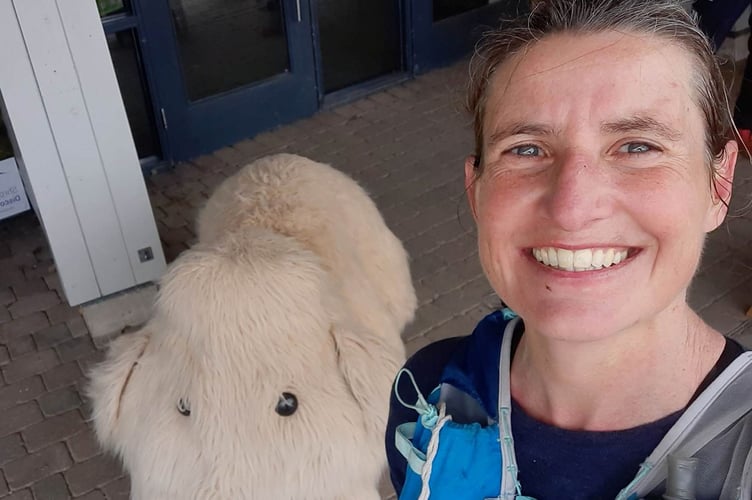 Louise Barker with her mammoth friend at the finish line.jpg