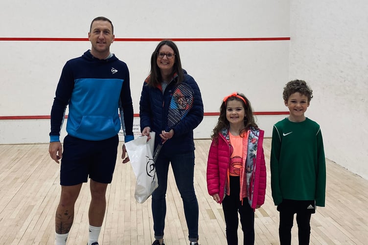 Dunlop giveaway winner receiving their prize from Head Squash Coach Damian Burgess at Plascrug Leisure Centre.