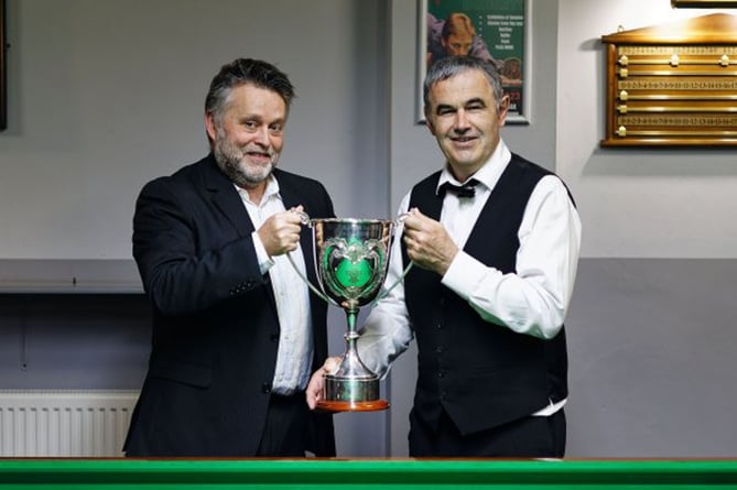 Pwllheli's Elfed Evans receiving the Welsh Amateur trophy from Tony Cannon