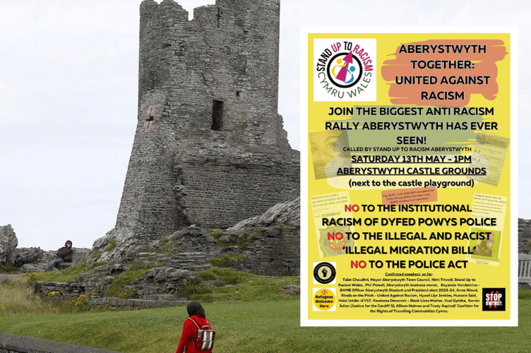 The castle grounds in the background and the protest poster