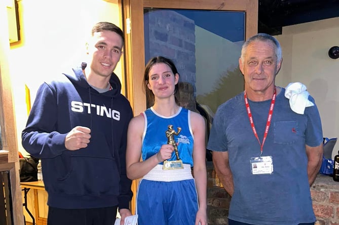 Debut win for Caitlin: A delighted Caitlin Fraser is pictured with Cardigan cornermen Garan Croft and head coach Guy Croft 200523