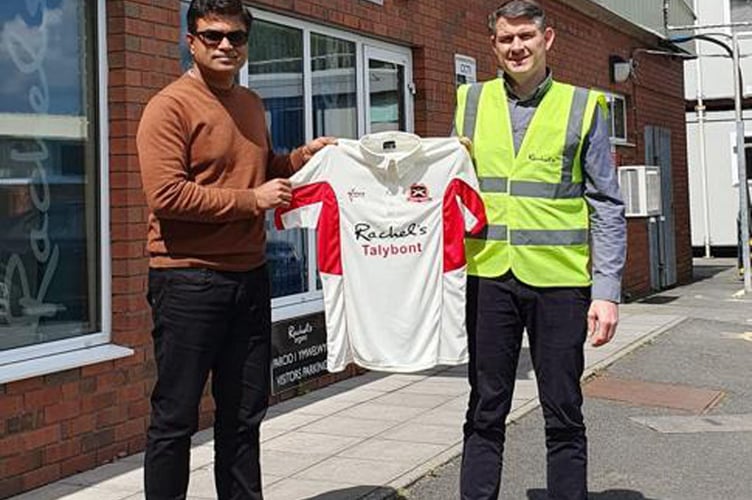 Richard Cooper of Rachel's Dairy presents a new shirt to Graison John