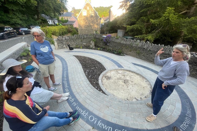 People sitting in the new community garden