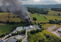 Drone footage shows fire at body repair business