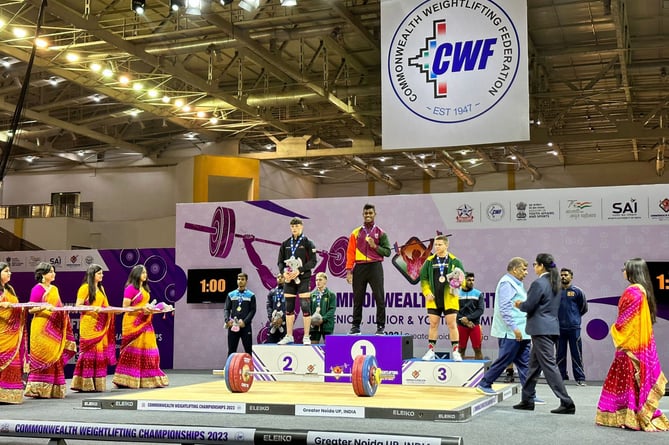 Cian Green on the podium at the commonwealth weightlifting championships 2023