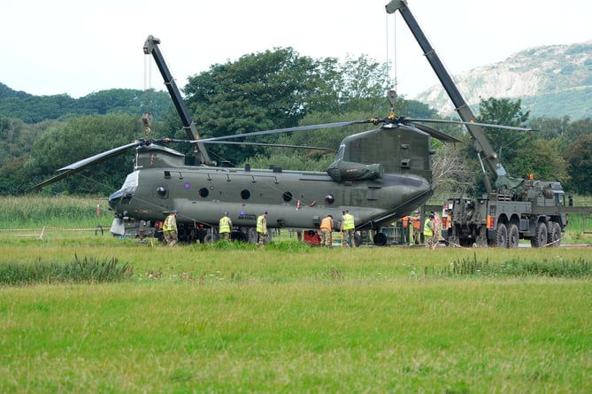 RAF Chinook had a controld  landing in a field in Arthog Gwynedd last Thursday after hydraulic failur on the rear rotors last Week in the dark.
amazing pilot skills to miss all power lines near by.
The Chinook is now bogged in and will need to be repaired before they can get it out 
Today the Chinook Friday 4th August where two crains are in position to lift the Chinook up for matting to be placed under the wheels to be cheaked under the body work 
Picture Erfyl Lloyd Davies Phtogaphy 
