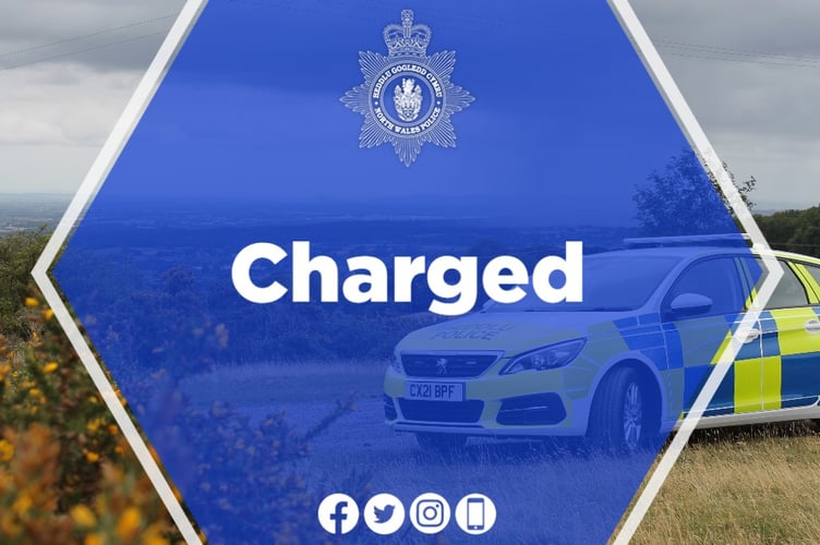 North Wales Police have charged two people