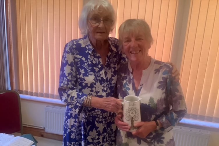 Captain Lynda Evans presenting the overall prize to Sue Wilson