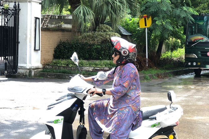 A student on one of the mopeds in Pakistan