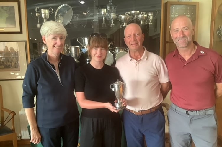 Rhian Raw Rees and Jeff Evans (middle) being presented with the Ashley Jones Cup by vice captains Catrin Pugh Jones and Alan Shaw