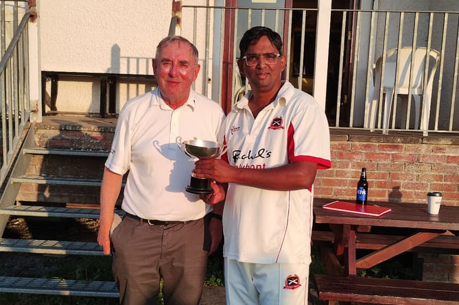 Robin Varley presents the trophy to Vinod Matthew