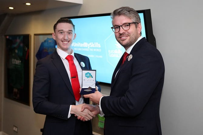 Ben Blackledge the CEO of WorldSkills UK gives Daniel Davies his award