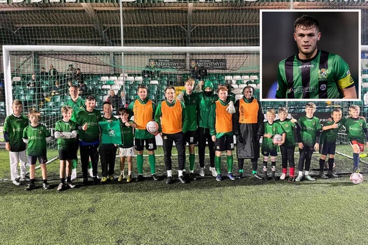 Pupils form Ysgol Comins Coch were at Park Avenue on Friday evening to support the Black & Greens. Inset: Aber captain Jack Thorn pulled one back for the Seasiders