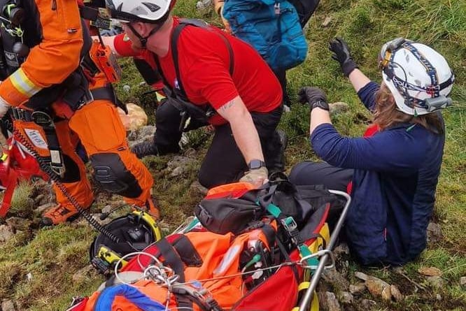The team attend to a walker who fell over 40ft